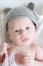 Portrait of lovely newborn in gray knitted hat