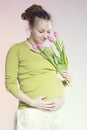 Portrait of lovely pregnant woman with tulips