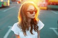 Portrait of lovely pretty young redhead hipster woman with lips in trendy sunglasses in white t-shirt