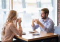 Portrait of lovely romantic couple sitting in urban cafe with fresh coffee, enjoying their date, having friendly chat Royalty Free Stock Photo