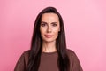 Portrait of lovely satisfied glad young girl nice long hair empty space ad isolated on pink color background