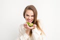 Portrait of a lovely smiling young brunette caucasian woman wearing the white shirt with long hair holding and showing Royalty Free Stock Photo