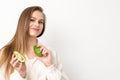 Portrait of a lovely smiling young brunette caucasian woman wearing the white shirt with long hair holding and showing Royalty Free Stock Photo