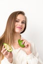 Portrait of a lovely smiling young brunette caucasian woman wearing the white shirt with long hair holding and showing Royalty Free Stock Photo