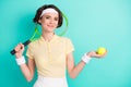 Portrait of lovely sportive cheery girl holding in hand racket tennis ball isolated over bright teal turquoise color Royalty Free Stock Photo