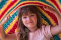 Portrait of lovely toddler girl playing under blanket. Lifetime moments and happy childhood concept