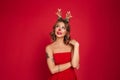 Portrait of a lovely toughtful girl wearing christmas deer costume