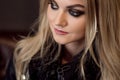 Portrait of a lovely young blonde with the eye makeup. Smokey eyes close-up. Royalty Free Stock Photo