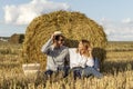 Portrait of lovers on hay background. Happy smiling couple in love during a picnic in field.