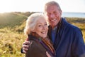 Portrait Of Loving Active Senior Couple Walking Along Coastal Path In Autumn Together Royalty Free Stock Photo