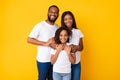 Happy black husband posing with wife and smiling daughter Royalty Free Stock Photo