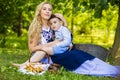 Portrait of Loving Caucasian Mother With Her Little Kid. Posing with Basket Full of Bread Rings Outdoors Royalty Free Stock Photo