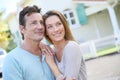 Portrait of loving couple smiling in front of their house Royalty Free Stock Photo