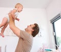 Portrait of a loving father lifting and playing with cute baby Royalty Free Stock Photo
