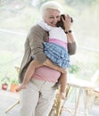 Portrait of loving grandmother carrying granddaughter at home Royalty Free Stock Photo