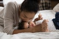 Loving biracial mom kiss cuddle little baby child Royalty Free Stock Photo