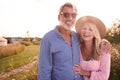 Portrait Of Loving Mature Couple In Countryside Hugging Against Flaring Sun Royalty Free Stock Photo