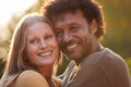 Portrait Of Loving Mature Couple Hugging Outdoors Against Flaring Evening Sun Royalty Free Stock Photo