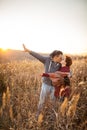 Portrait of loving middle-aged couple in warm clothes hugging in the autumn park at sunset in selective focus Royalty Free Stock Photo