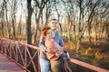 Portrait of loving middle-aged couple in warm clothes hugging in the autumn park at sunset in selective focus Royalty Free Stock Photo