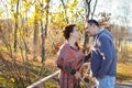 Portrait of loving middle-aged couple in warm clothes hugging in the autumn park at sunset in selective focus Royalty Free Stock Photo