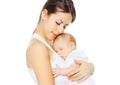 Portrait loving mother kissing her baby on white background Royalty Free Stock Photo