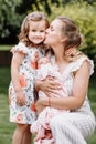 Portrait of loving mother and two adorable kids. little girl and newborn baby girl with mom outdoors on summer day. Happy family Royalty Free Stock Photo