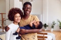 Portrait Of Loving Parents Holding Newborn Baby At Home In Loft Apartment Royalty Free Stock Photo