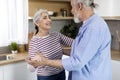 Portrait Of Loving Senior Couple Dancing Together In Kitchen Interior, Royalty Free Stock Photo