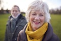 Portrait Of Loving Senior Couple Enjoying Autumn Or Winter Walk Through Park Together Royalty Free Stock Photo