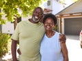 Portrait Of Loving Senior Couple Outdoors Hugging In Front Of Home Royalty Free Stock Photo