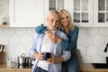 Portrait Of Loving Senior Couple Relaxing With Coffee In Kitchen Interior Royalty Free Stock Photo