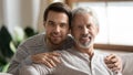 Portrait of loving senior dad and adult son hugging Royalty Free Stock Photo