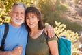 Portrait Of Loving Senior Hispanic Couple Hiking Along Trail In Countryside Together Royalty Free Stock Photo