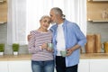 Portrait Of Loving Senior Spouses Relaxing With Coffee In Kitchen Interior Royalty Free Stock Photo