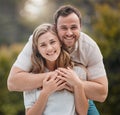 Portrait of loving young caucasian couple spending time together outdoors on a sunny day. Handsome smiling man holding Royalty Free Stock Photo