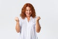 Portrait of lucky winning middle-aged redhead woman celebrating victory, scream happy and amazed, fist pump pleased