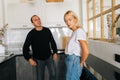 Portrait of mad emotional boyfriend scolding, raising voice, screaming at ignoring young wife wife standing in kitchen Royalty Free Stock Photo