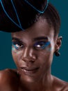 Portrait, makeup and eye shadow with a black woman in studio on a blue background for beauty. Face, hair and cosmetics Royalty Free Stock Photo