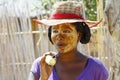 Portrait of malagasy woman with tradytional mask on the face