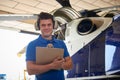 Portrait Of Male Aero Engineer With Clipboard Carrying Out Check