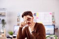 Portrait Of Male Architect In Office Working At Desk Looking Through Wooden Model Of Building Royalty Free Stock Photo