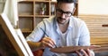 Portrait Of Male Artist Working On Painting In Studio Royalty Free Stock Photo