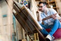 Portrait Of Male Artist Working On Painting In Studio Royalty Free Stock Photo