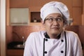 Portrait of male Asian chef thinking something, successful chef in restaurant culinary business concept