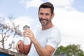 portrait male basketball holding sports ball under arm