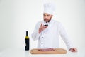 Portrait of a male chef cook degusting wine Royalty Free Stock Photo