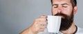 Portrait male. Closeup tea. Good morning, man holding a cup tea. Morning concept. Handsome bearded male holds cup of