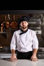 portrait of chef cook in white uniform posing at camera seriously looking at camera Royalty Free Stock Photo