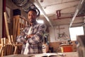 Portrait Of Male Craftsman In Carpentry Workshop For Bamboo Bicycles  Doing Accounts On Laptop Royalty Free Stock Photo